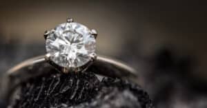 Brilliant diamond engagement ring with a round-cut center stone set in a platinum band, showcasing fine jewelry craftsmanship.