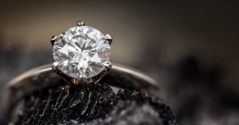 Brilliant diamond engagement ring with a round-cut center stone set in a platinum band, showcasing fine jewelry craftsmanship.