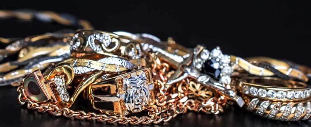 Shimmering gold and silver jewelry collection featuring rings, chains, and bracelets adorned with sparkling diamonds, perfect for luxury jewelry lovers and special occasions.