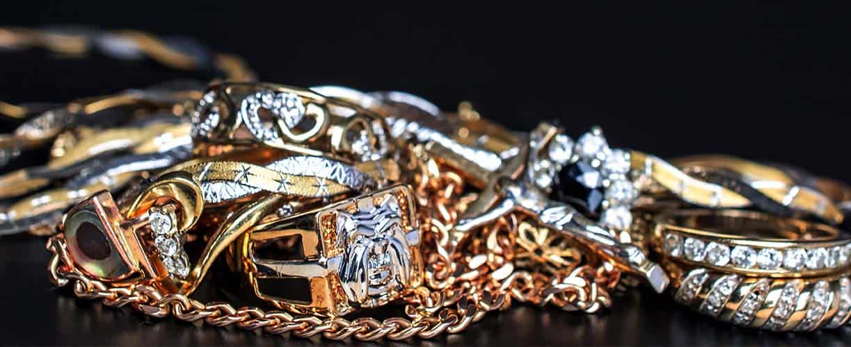 Shimmering gold and silver jewelry collection featuring rings, chains, and bracelets adorned with sparkling diamonds, perfect for luxury jewelry lovers and special occasions.