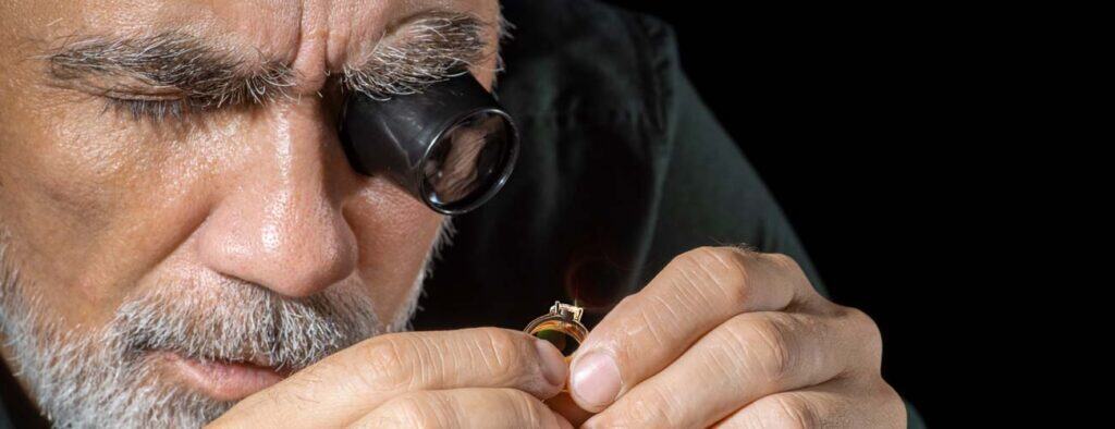 Precise jewelry inspection by a professional jeweler using a magnifying loupe at david stern jewelers.