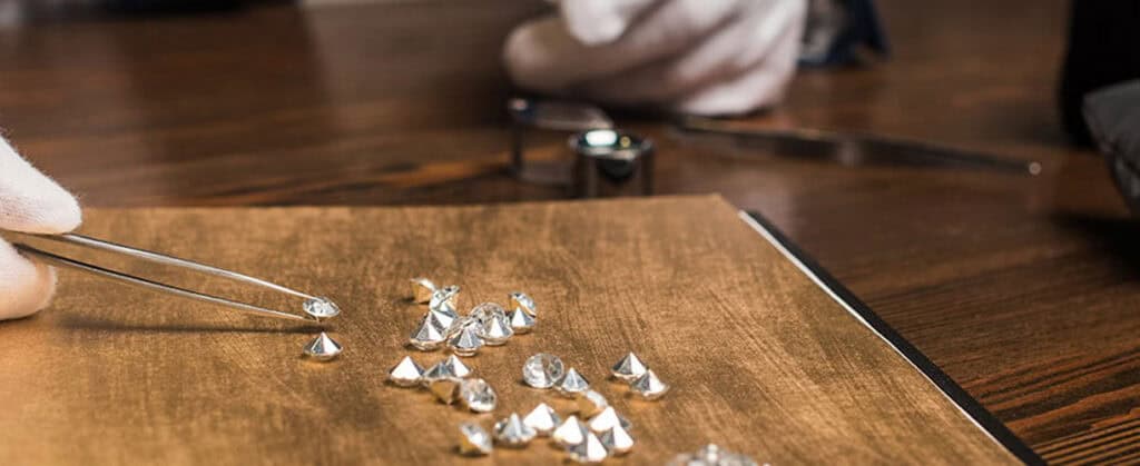 Shaping and setting diamonds for custom jewelry at david stern jewelers, showcasing expert craftsmanship in fine diamond jewelry design and repair.