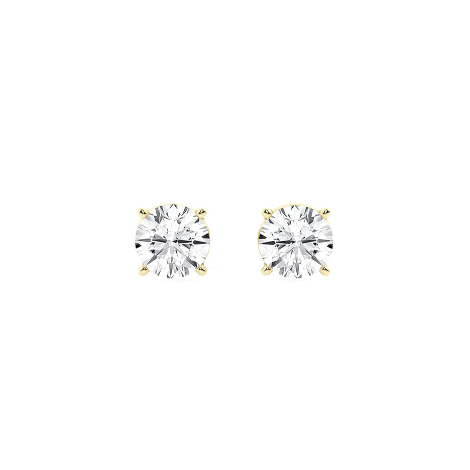 Round diamond stud earrings in yellow gold setting, showcasing elegant and timeless jewelry designs. Perfect for special occasions or everyday luxury from David Stern Jewelers.