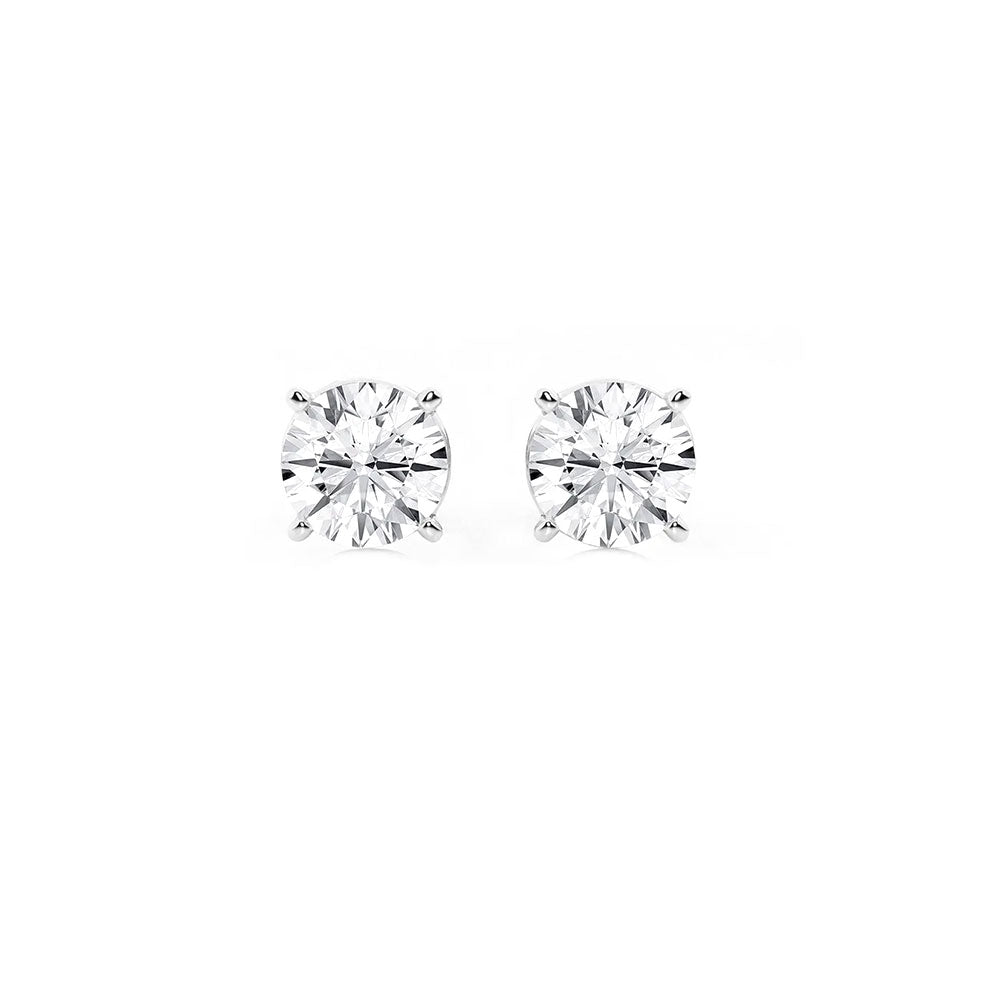 Round diamond stud earrings with platinum settings, perfect for engagement or everyday jewelry. Fine quality diamond jewelry from David Stern Jewelers.