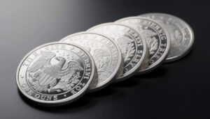 Close-up of silver coins, showcasing their detailed designs, available for buying and selling at David Stern Jewelers in Boca Raton.