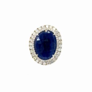 Oval sapphire halo ring seen head on: an 8.00 ct faceted oval blue sapphire inside two rows of round diamonds in 14kt white gold