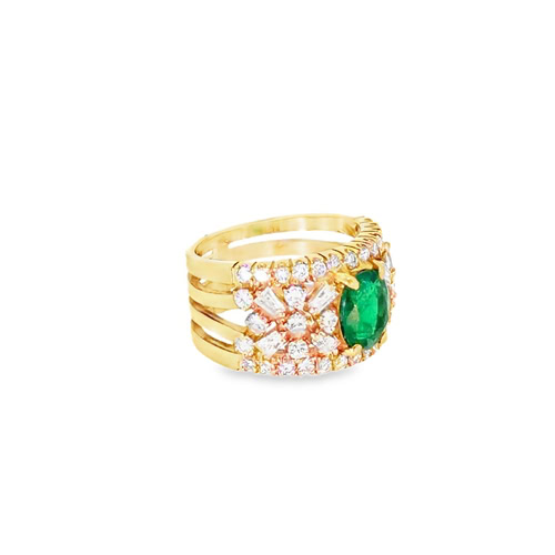 The emerald cocktail ring from the other side, showing the mixed round and baguette diamonds set across the band