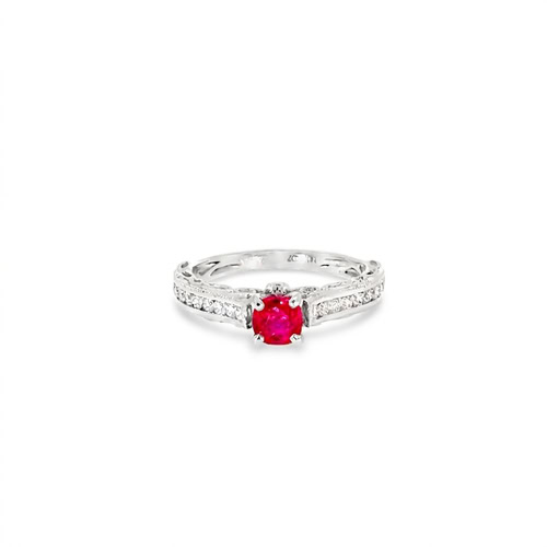 Vintage style ruby ring seen head on: a 0.44 ct round ruby in six prongs above diamond-set shoulders in 18kt white gold