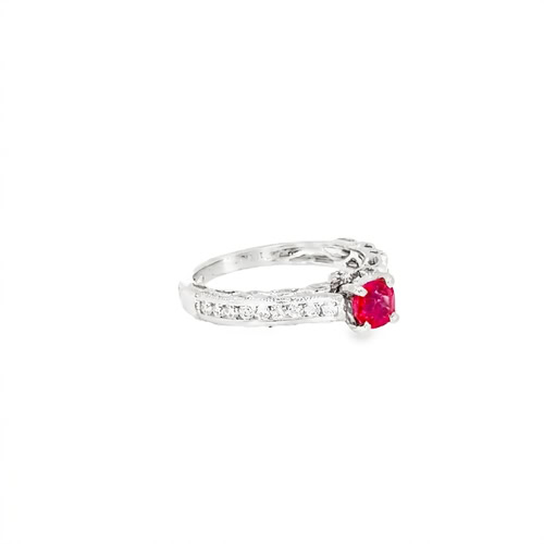 Side view of the vintage style ruby ring, showing the engraved gallery and the diamonds running down the shoulder
