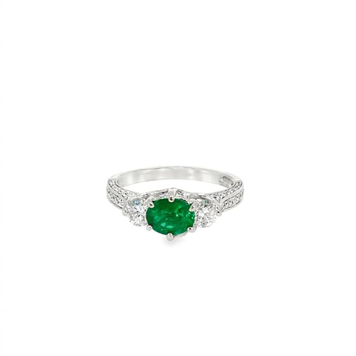 Oval emerald ring seen head on: a 0.75 ct oval emerald between two round diamonds on a pave band in 14kt white gold