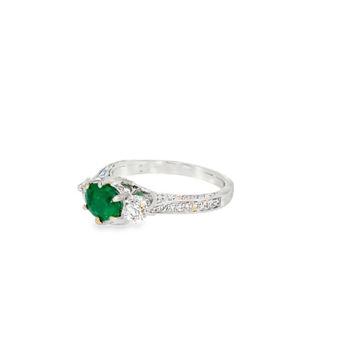 The emerald and diamond ring from the other side, showing the engraved gallery and tapered band
