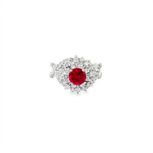 Lab grown ruby cocktail ring seen head on: a 1.00 ct round lab-grown ruby inside a starburst halo of diamonds