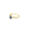Yellow gold tanzanite ring from the other side, with the round diamonds set in individual prongs along the shank