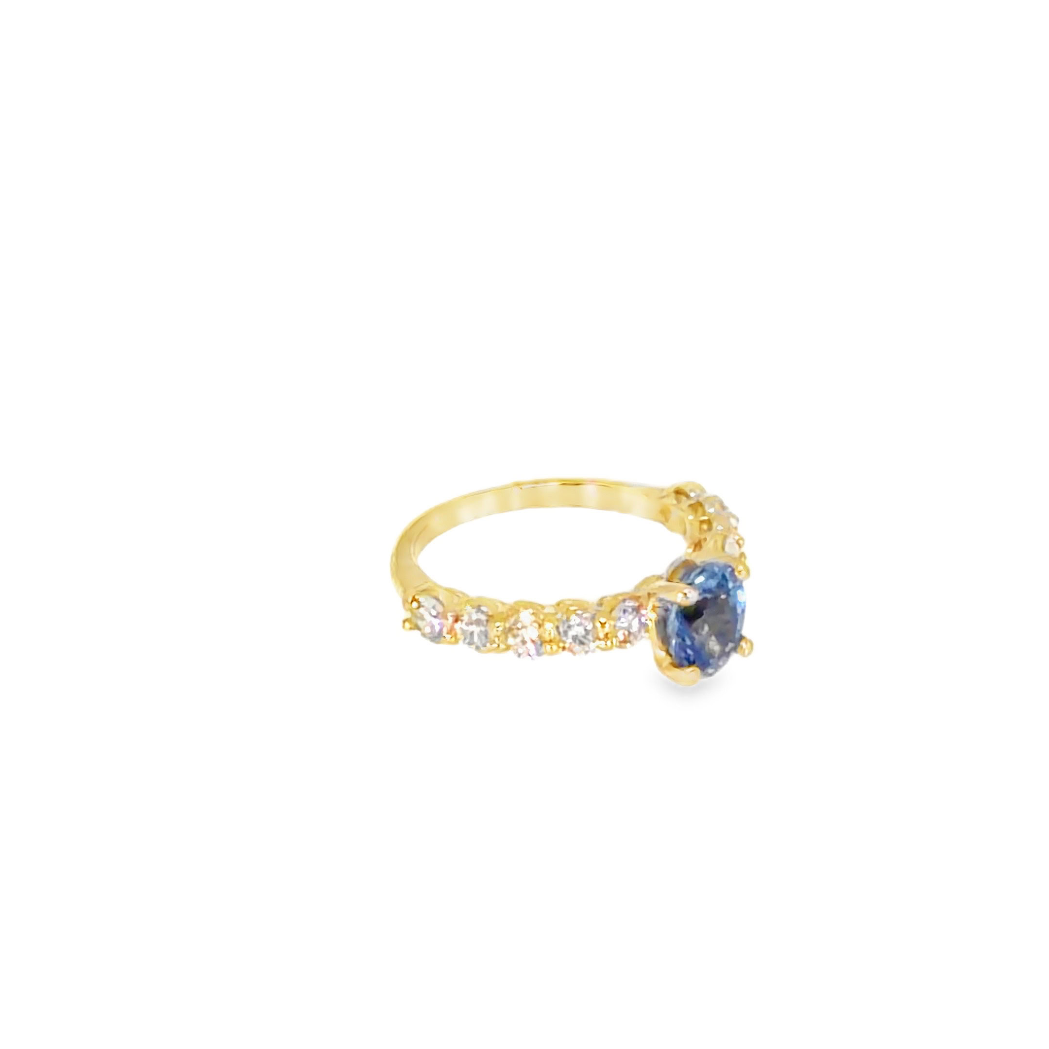 Side view of the oval tanzanite ring showing the four-prong center and prong-set diamonds along the band