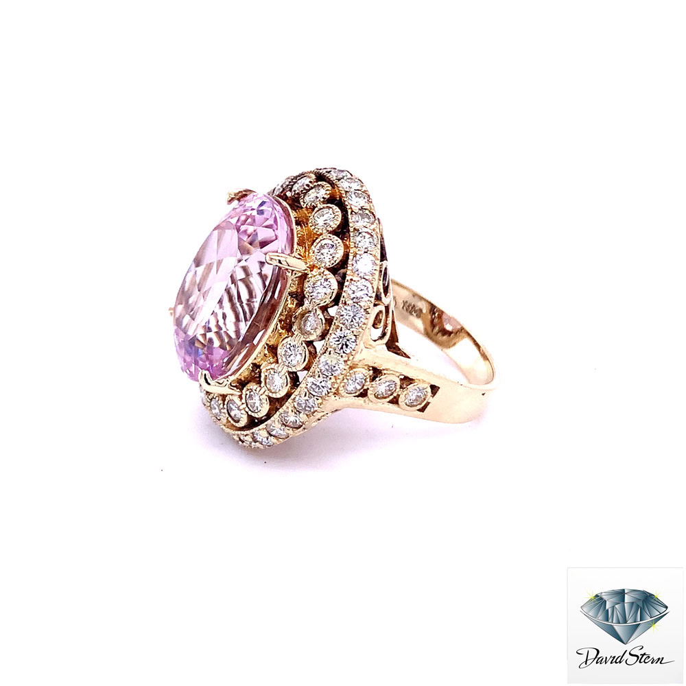 Large morganite ring seen from the left, showing the collar-set inner halo and diamond shoulders in yellow gold