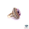 Side view of the morganite and diamond ring showing the double halo, scrolled openwork gallery and diamond shoulders