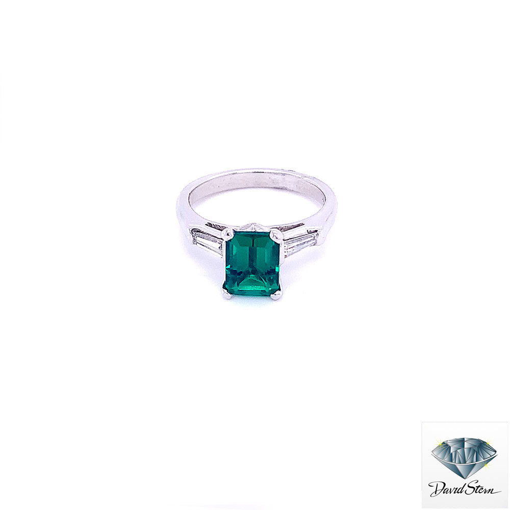 Chatham emerald engagement ring: 1.40 ct emerald-cut Chatham lab-created emerald between two tapered baguette diamonds in platinum