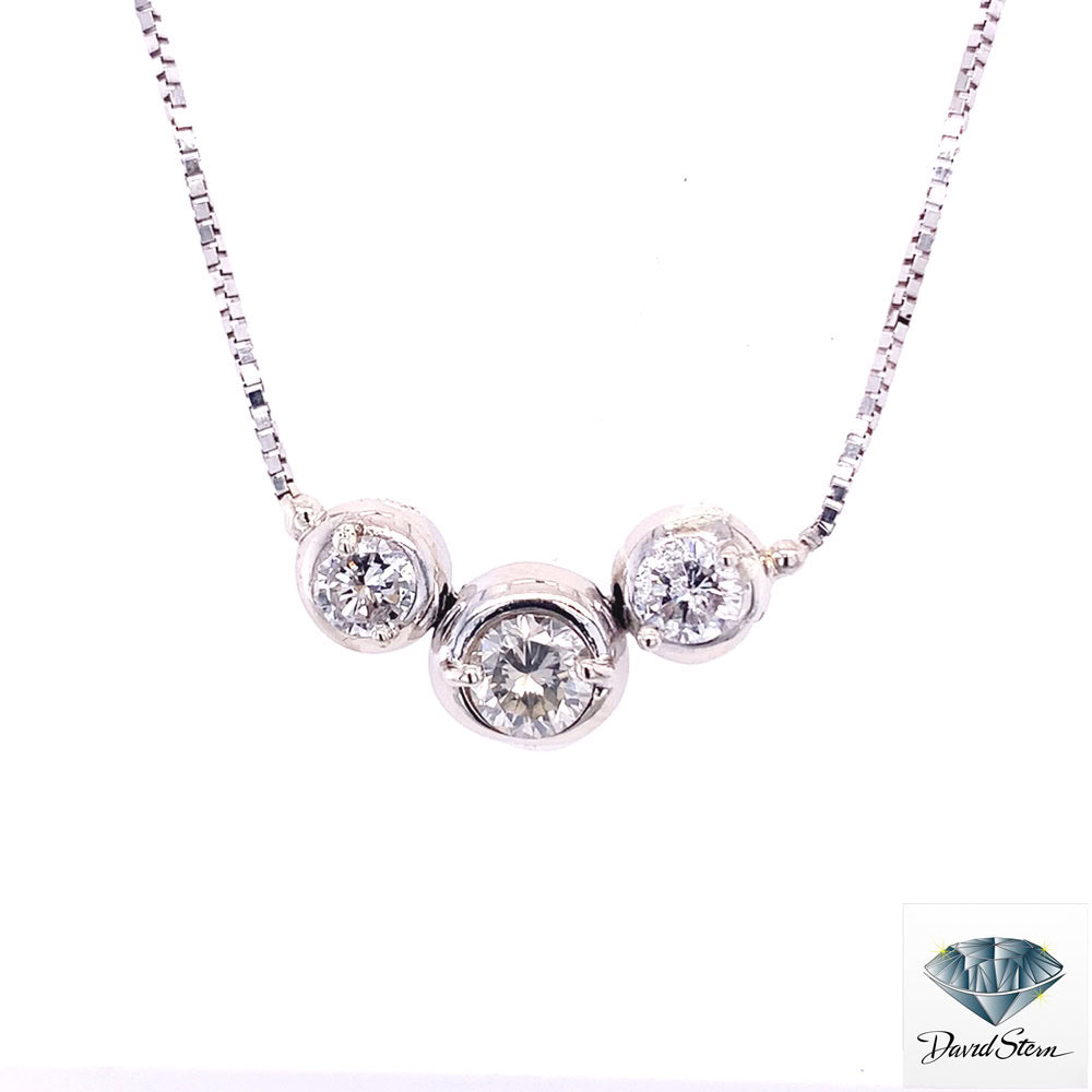 Three-stone diamond necklace in white gold, a classic anniversary jewelry design