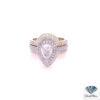 Pear halo engagement ring: 1.05 ct pear diamond in a white gold pave halo, framed above and below by a yellow gold diamond ring enhancer