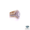 Side view of the pear diamond bridal set showing the white gold halo ring between two yellow gold pave enhancer bands