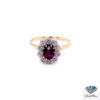 Vintage ruby engagement ring: oval ruby in a cluster of old-cut diamonds on a slender 18kt yellow gold band