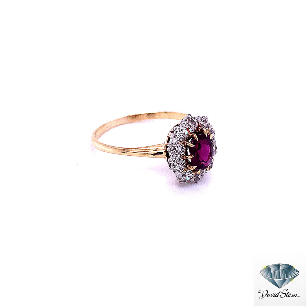 Side view of the ruby halo ring showing the old-cut diamond cluster and slender yellow gold band