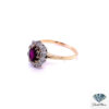 Antique style engagement ring seen from the left: ruby and old-cut diamond cluster on 18kt yellow gold