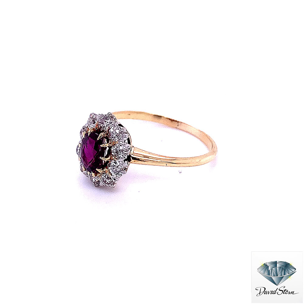 Antique style engagement ring seen from the left: ruby and old-cut diamond cluster on 18kt yellow gold