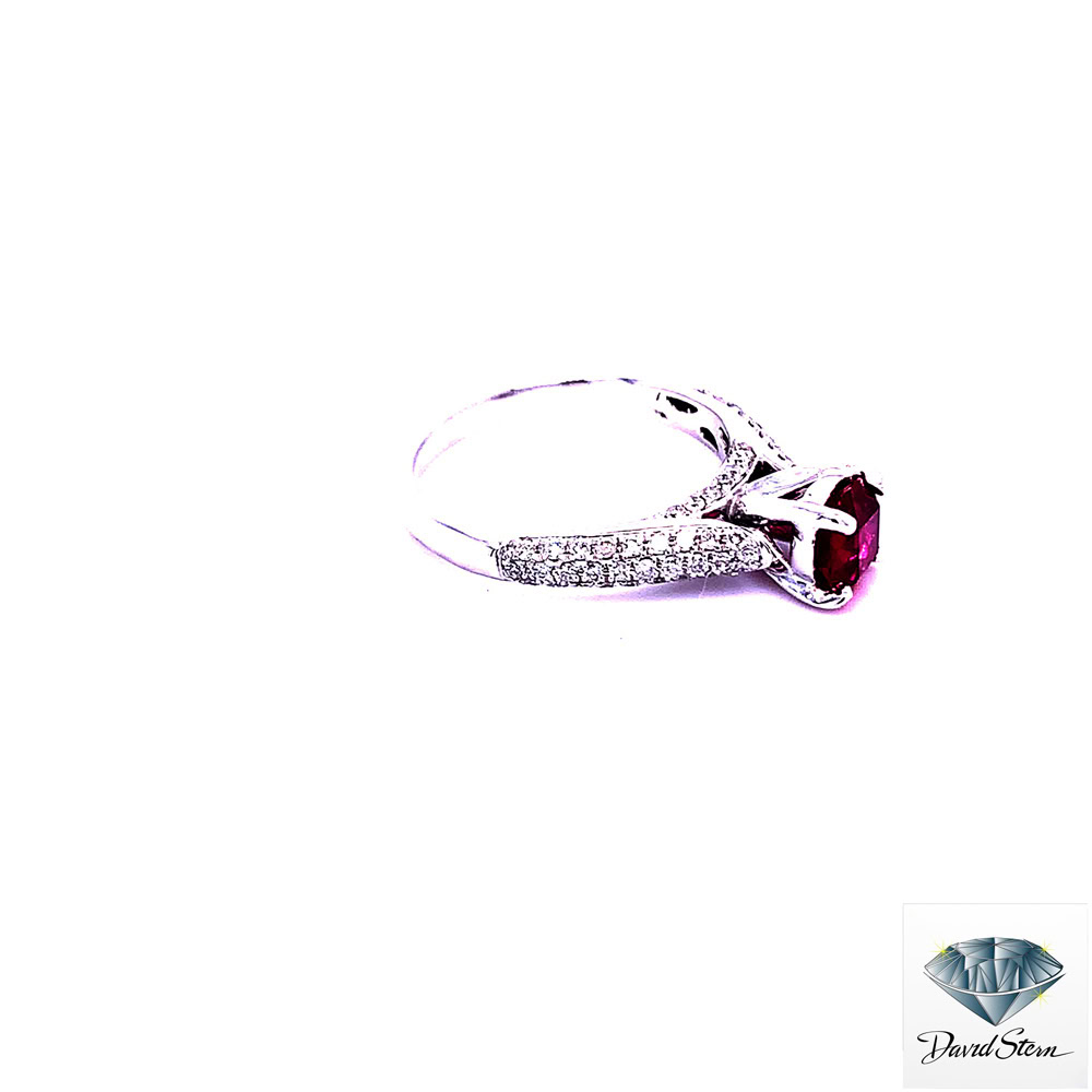 Side view of the pave ruby ring showing the raised four-prong head and three rows of pave diamonds on the shoulder