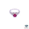 Round ruby engagement ring: 0.90 ct round ruby in four prongs on a 14kt white gold band with three rows of pave diamonds