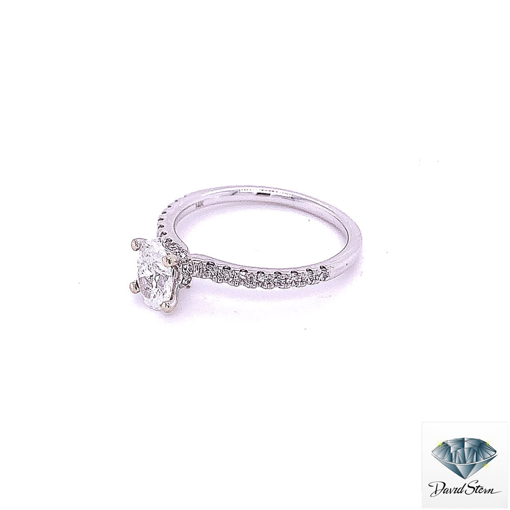 Side view of the diamond band engagement ring showing the single row of prong-set diamonds and the four-prong oval head