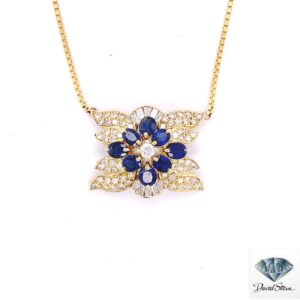 Sapphire flower necklace: eight oval blue sapphires around a round diamond with baguette and pave diamonds in 14kt yellow gold