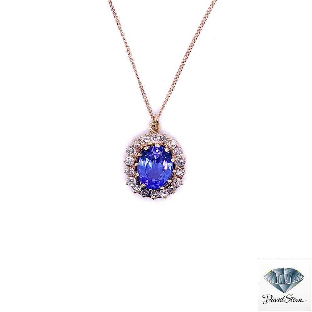 Tanzanite necklace: 2.50 CT oval tanzanite in a halo of European cut diamonds in 14kt yellow gold