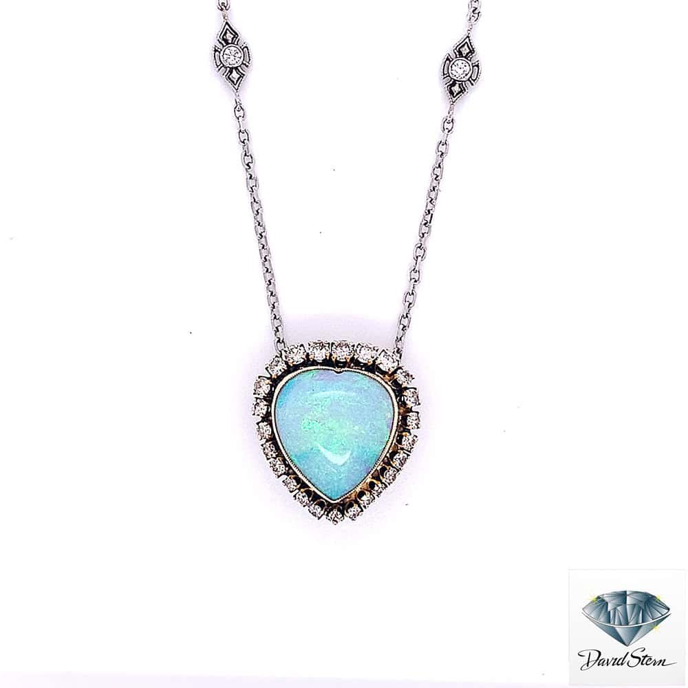 Heart opal necklace: 4.90 CT heart cabochon opal in a diamond halo with diamond chain stations, 6.30 CT total