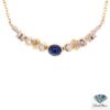 Cabochon sapphire necklace: oval cabochon sapphire between bezel-set diamonds and gold stations on a 14kt yellow gold chain