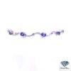 Tanzanite bracelet: oval tanzanites and small diamonds on wavy 14kt white gold links