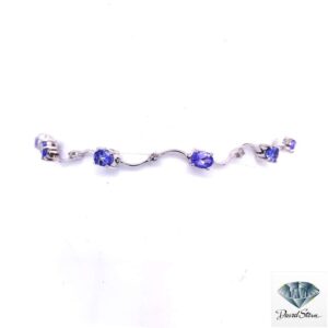 Tanzanite bracelet: oval tanzanites and small diamonds on wavy 14kt white gold links