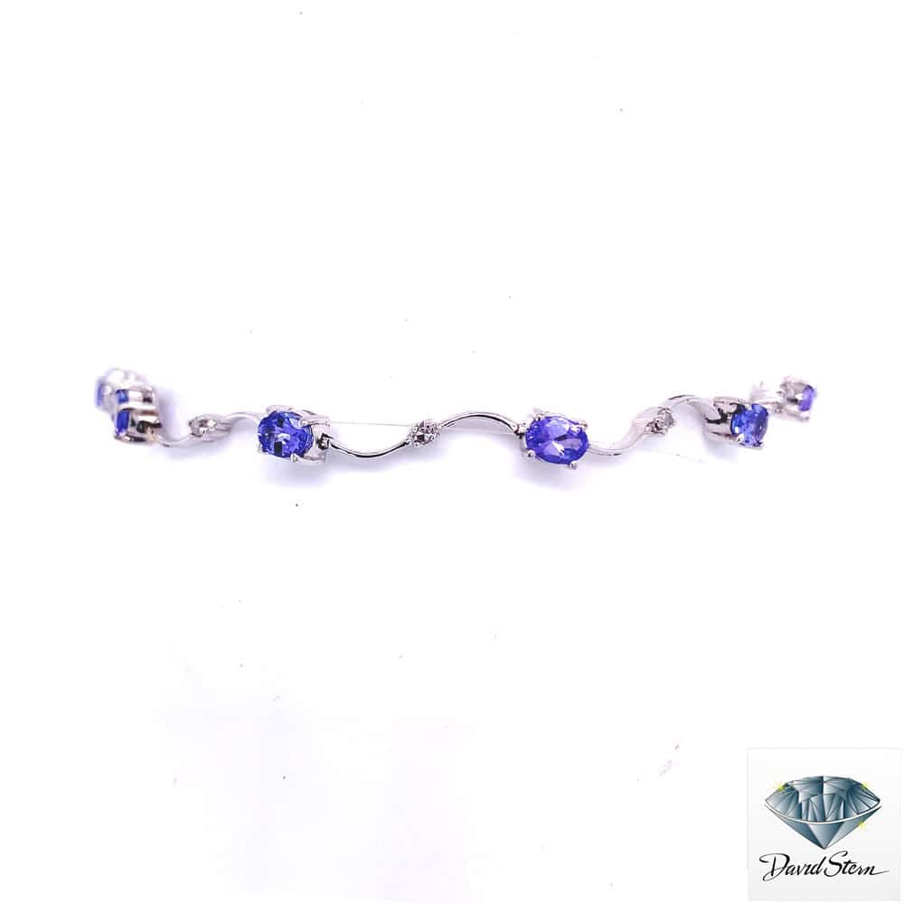 Tanzanite bracelet: oval tanzanites and small diamonds on wavy 14kt white gold links