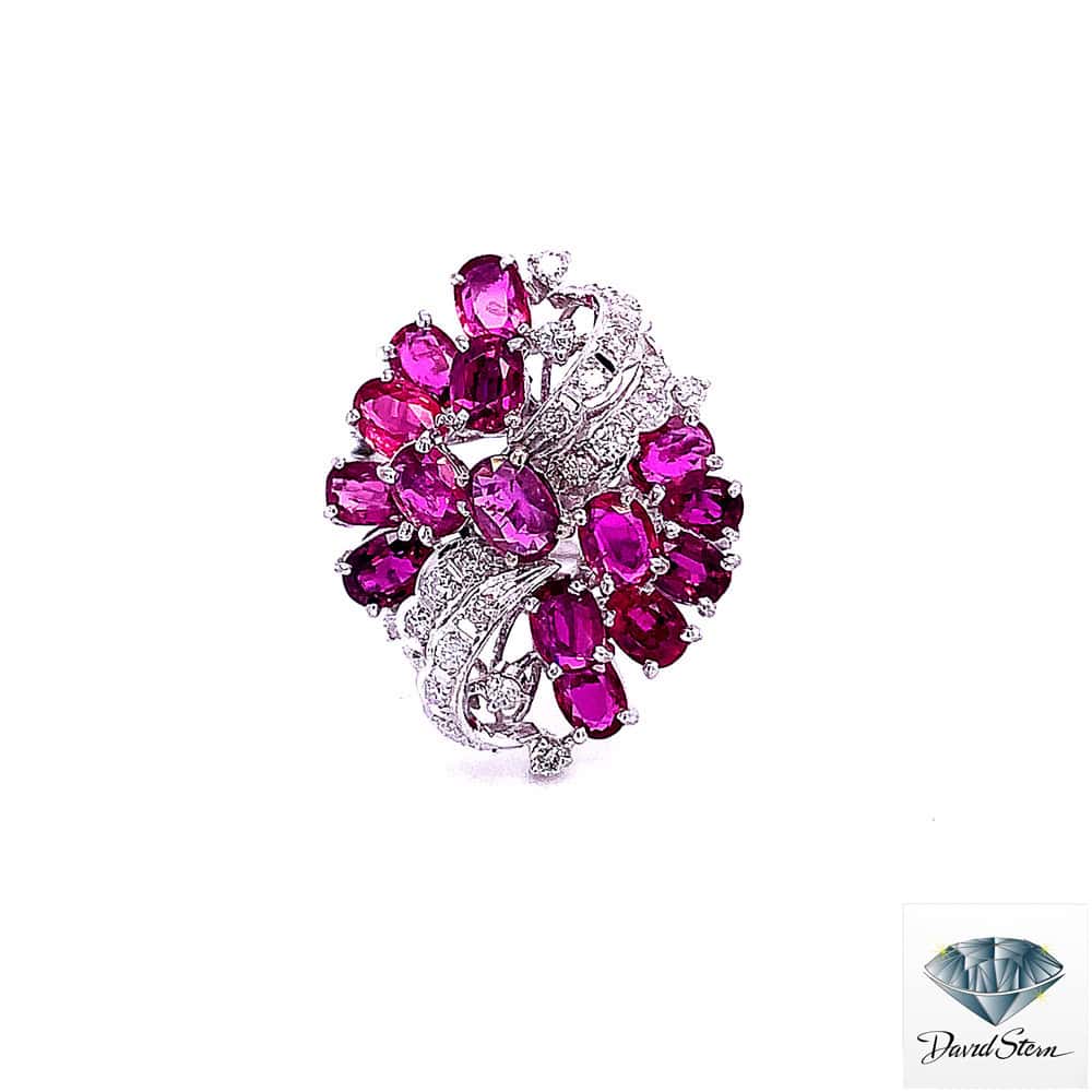 Ruby cocktail ring: fifteen oval rubies in a cluster with a diamond ribbon, 14kt white gold
