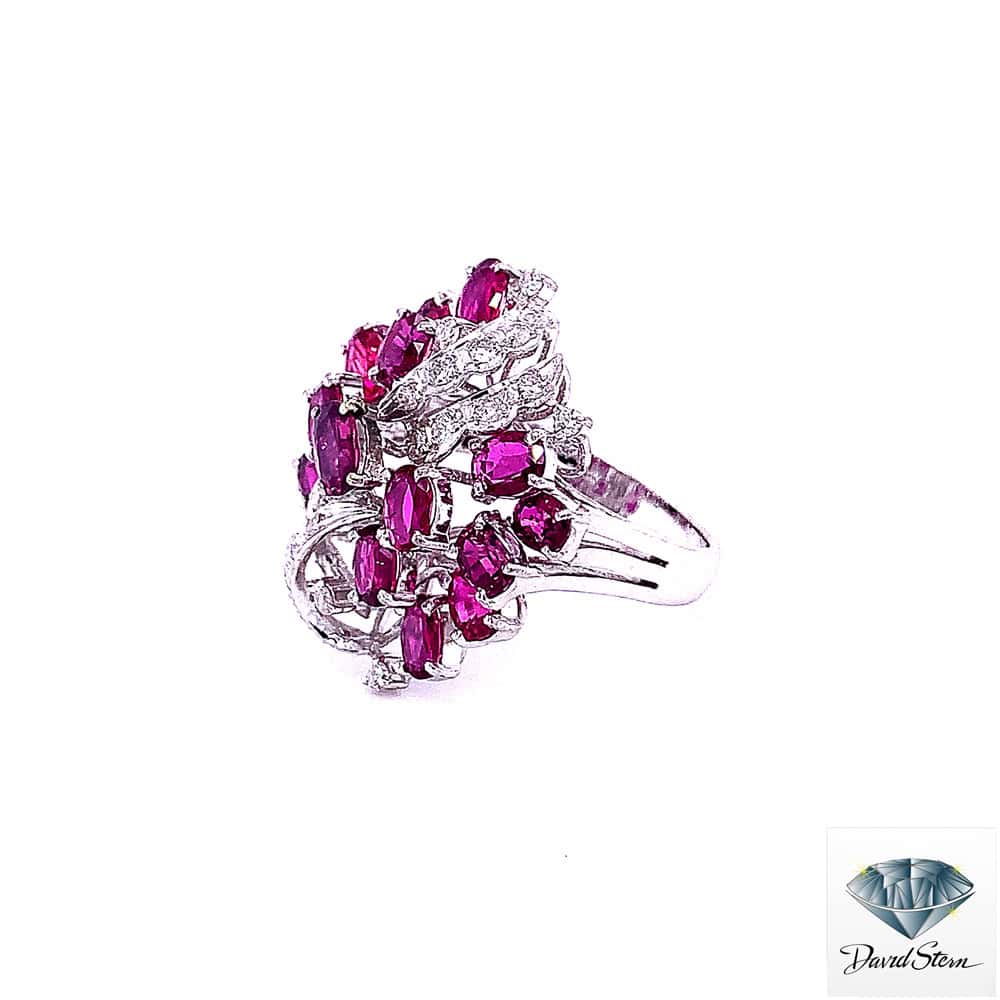 Side view of the ruby cocktail ring showing the tall ruby cluster and openwork gallery