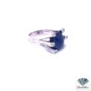 Other side of the large sapphire ring showing the white gold shank and bezel-set diamonds