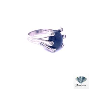 Other side of the large sapphire ring showing the white gold shank and bezel-set diamonds