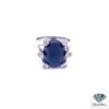 Sapphire cabochon ring: 15.36 CT oval blue sapphire held by six diamond-tipped arms in 14kt white gold