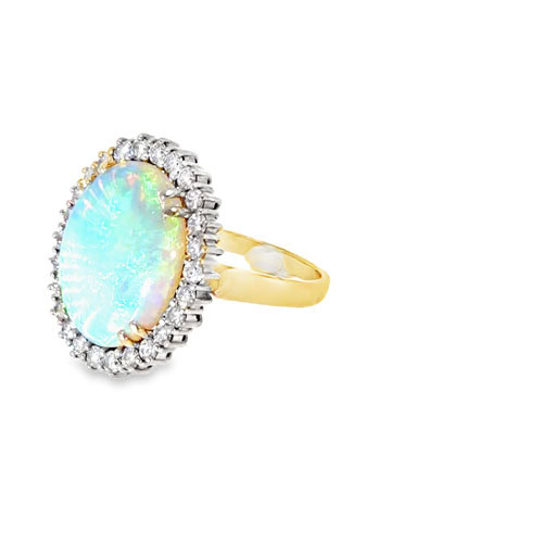Side view of the two tone opal ring showing the white gold diamond halo head and the 14kt yellow gold shank