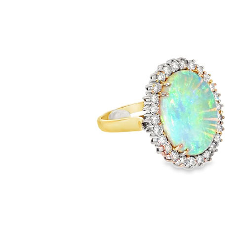 The blue green opal ring seen from the other side, showing the prong-set diamond halo and the yellow gold band