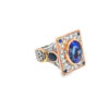 The tanzanite couture ring from the other side, showing the raised rectangular head and the pierced white gold gallery