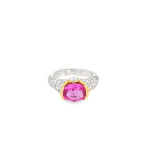 Pink ruby ring: a 2.25 ct oval pink ruby set east to west in a 14kt yellow gold bezel on a pave diamond platinum band