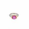 Pink ruby ring: a 2.25 ct oval pink ruby set east to west in a 14kt yellow gold bezel on a pave diamond platinum band