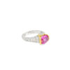 The pink ruby ring from the other side, showing the pave diamond shoulders tapering into the platinum band
