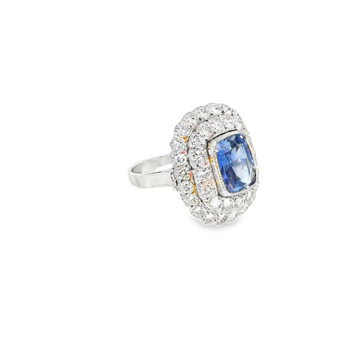 Angled view of the cushion sapphire ring, showing the raised double halo above the platinum shank